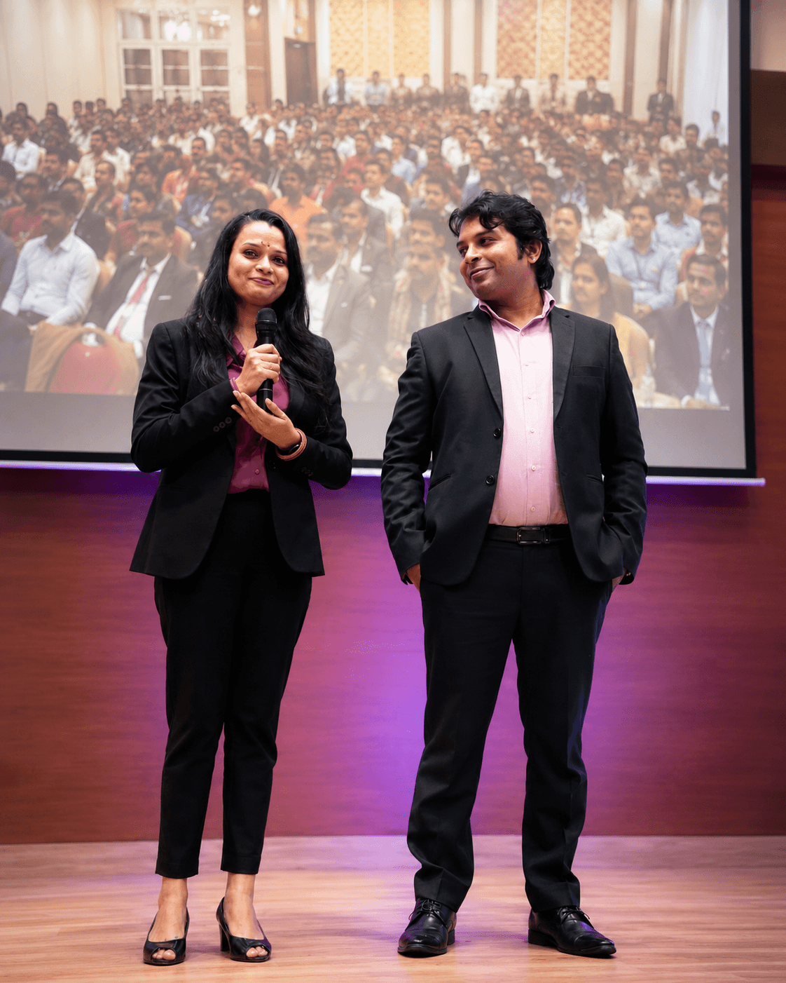 Deepa and Prateek speaking on stage